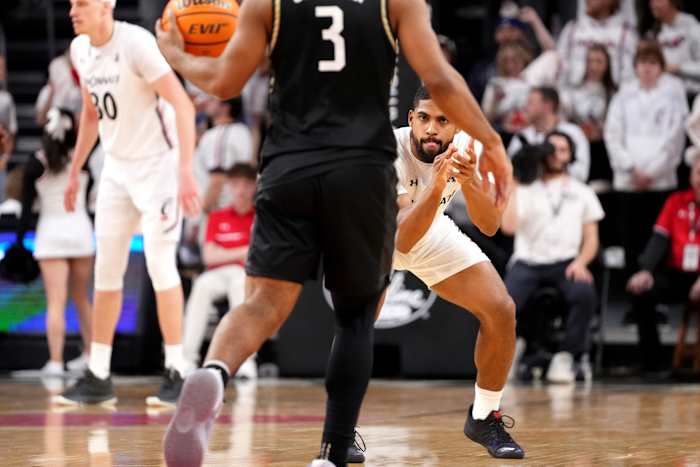 Cincinnati Bearcats guard David DeJulius (5) prepares to defend as UCF Knights guard Darius Johnson (3) dribbles the ball up-court in the second half of a college basketball game between the UCF Knights and the Cincinnati Bearcats, Saturday, Feb. 4, 2023, at Fifth Third Arena in Cincinnati. The Cincinnati Bearcats won, 73-64. Ucf Knights At Cincinnati Bearcats Feb 4 0241